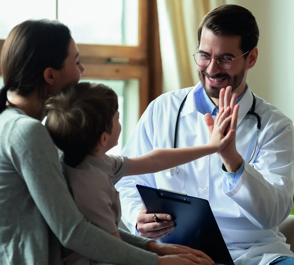 Concierge doctor greeting a young patient and her mother
